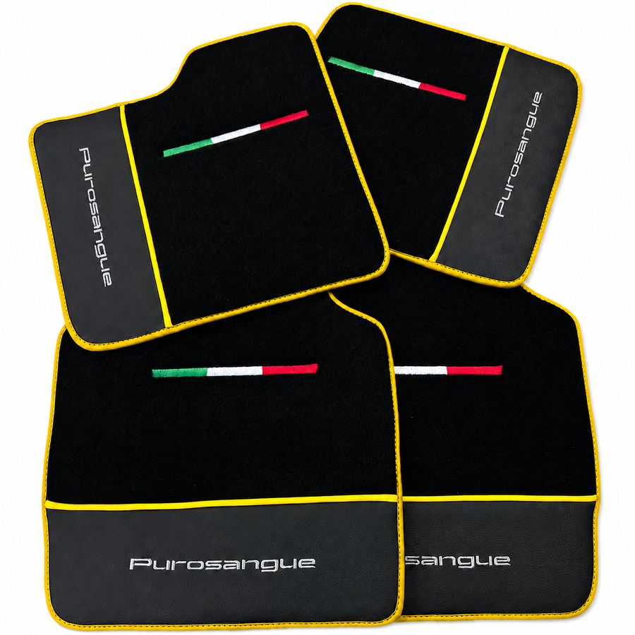 Four black car floor mats with yellow trim, featuring a small Italian flag emblem and the white 'Purosangue' brand name on a clean white background.